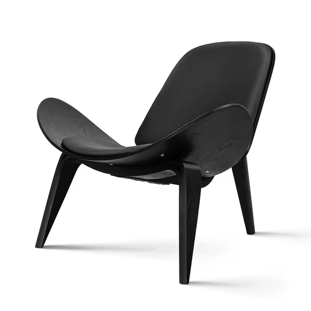 Shell Chair with a black frame and black vegan leather upholstery, showcasing its sleek design and modern aesthetic.