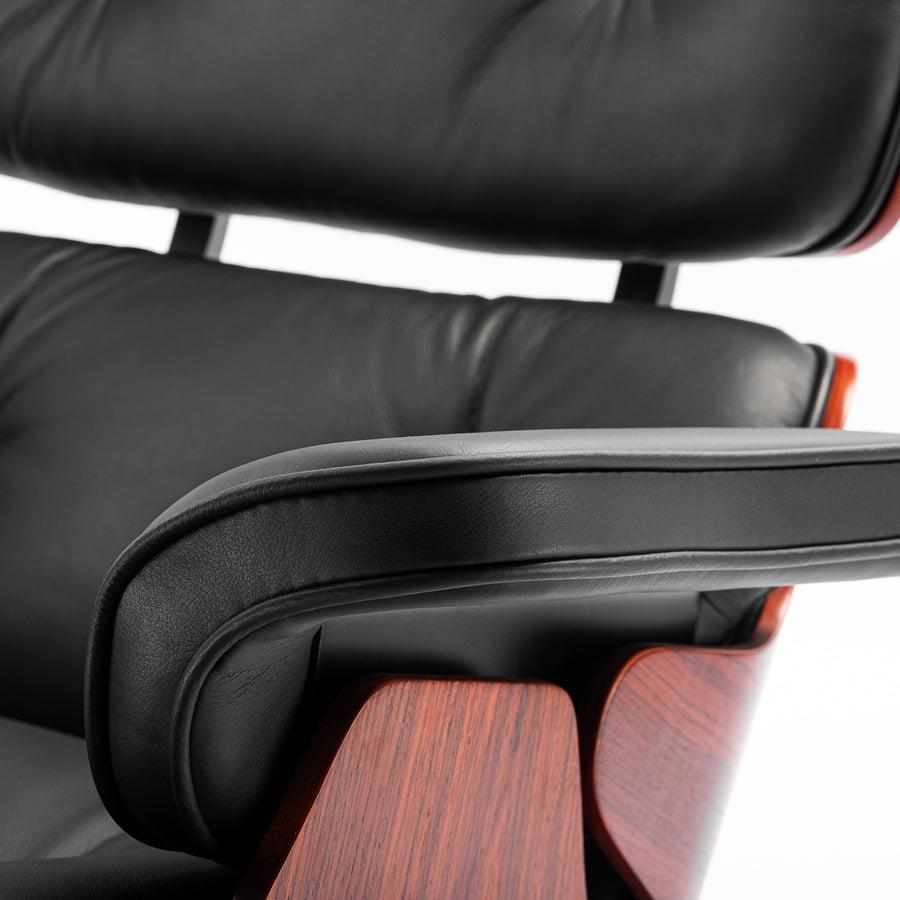 Close-up of the arm of the XL Tall Replica Eames Lounge Chair in rosewood and black leather, showcasing the detailed craftsmanship and luxurious finish.